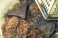 Grater and grated chocolate closeup