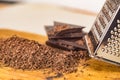 Grater and grated chocolate closeup Royalty Free Stock Photo
