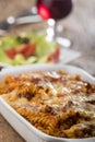 Gratinated pasta on wood Royalty Free Stock Photo