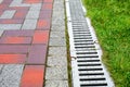 Grating of the drainage system for drainage of rainwater in the park. Royalty Free Stock Photo