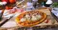 Grating parmesan cheese over a pizza margherita Royalty Free Stock Photo