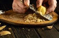 Grating raw potatoes with a grater in the hands of a cook. Preparing a vegetable menu for a vegetarian dinner Royalty Free Stock Photo