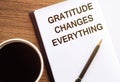 Gratitude changes everything - writing on notepad with a cup of espresso coffee Royalty Free Stock Photo