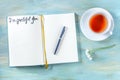 Gratitude journal with a pen and a cup of tea, with the handwritten phrase I am grateful for Royalty Free Stock Photo