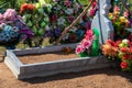 grave with flowers and funeral wreaths