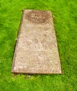 The grave of Willaim III the King of the Scots, ruins of the abbey behind it, at Arbroath Abbey, Arboath, Angus,Scotland,UK