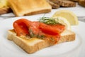 Graved salmon on toast bread with dill and lemon