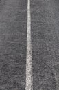 A gravel bicycle path with a single white dividing line