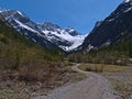 Gravel path leading through Oytal valley near Oberstdorf, Bavaria, Germany in the Allgeau Alps in spring with mountains.