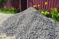 Gravel pile near hous fence for construction