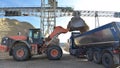 Gravel pit: building and wheel loader loading gravel onto a truck