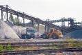 Gravel pit, loader loads gravel on a dump truck