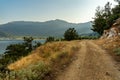 Gravel road along the Aegean seacoast Thassos island, Greece, scenic tourist destination, countryside Royalty Free Stock Photo