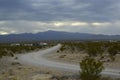 Monsoon rain clouds over mountain range edge of dry Mojave Desert valley Nevada, USA