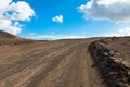 Gravel road through the breathtaking coastal area of Lanzarote, Spain