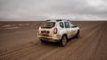 Gravel road with car in Skeleton Coast Park, Namibia. Royalty Free Stock Photo