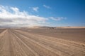 Gravel road with dunes in Skeleton Coast Park, Namibia. Royalty Free Stock Photo