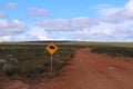 Gravel road with echidna wildlife traffic warning sign in the Western Australian outback Royalty Free Stock Photo