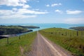 Gravel road between fence in farmland Royalty Free Stock Photo