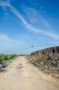 Gravel road full of garbage. Royalty Free Stock Photo