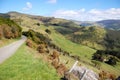 Gravel road goes downhill to rural valley