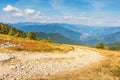 Gravel road through the mountain meadow Royalty Free Stock Photo