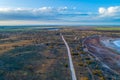 Gravel road passing through Australian desert. Royalty Free Stock Photo