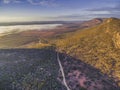 Gravel road passing through Australian outback. Royalty Free Stock Photo