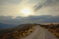 Dirt road throug Sierra Nevada mountains with dark threatening clouds