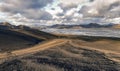 Gravel road to a braided glacial river and mountain range in Iceland`s remote Highlands, Sudurland, Iceland