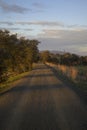 Gravel road to practice gravel cycling in Via Verde vertically at sunset Extremadura Royalty Free Stock Photo