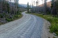 A gravel road twists through the Custer Gallatin National Forest near Red Lodge, Montana, USA