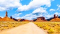 Gravel Road winding through the landscape of Red Sandstone Buttes and Pinnacles in the desert landscape in the Valley of the Gods