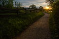 The gravelly path leads to the lake in the sunset Royalty Free Stock Photo