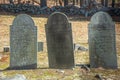 Three Old Headstone with faint markings in an old New England Cemetery on a sunny, bright spring day.