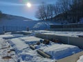 Graves in a snowy modern cemetery in winter with blue sky and sunshine in Jarrier Maurienne Savoie France