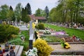 Graves / tombstones in the cemetery / graveyard. All Saints Day / All Hallows / 1st November. Flowers and candles on tomb stone Royalty Free Stock Photo