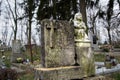 Graves, tombstones and crucifixes on traditional cemetery. Statue of an angel on old tomb stone in graveyard. All Saints' Day Royalty Free Stock Photo