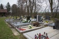 Graves, tombstones and crucifixes on traditional cemetery. Votive candles lantern and flowers on tomb stones in graveyard Royalty Free Stock Photo