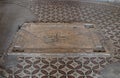 Gravestone with a cross on the floor of the Dominus Flevit Church on the Mount Eleon - Mount of Olives in East Jerusalem in Israel