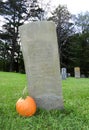 Centuries old gravestone with Autumn pumpkin decoration Royalty Free Stock Photo