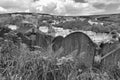 Gravestones overgrown with weeds overlooking the town of hebden bridge at the disused cross lanes former methodist burial ground