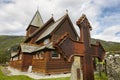 Graveyard rusted catholic cross. Norwegian stave church. Roldal