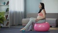 Gravid lady keeping vlog for future moms showing how to soothe feet after stress