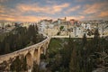 Gravina in Puglia, Bari, Italy: landscape at sunrise of the old town and the ancient aqueduct bridge Royalty Free Stock Photo