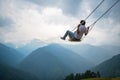 Gravity-Defying Delight: Man Hanging Loose in Orange T-Shirt