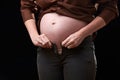 the inconvenience of pregnancy. a pregnant woman can't fasten her pants. gravity of movements of the pregnant woman Royalty Free Stock Photo