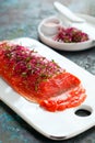 Gravlax, homemade salted sockeye salmon fillet with beetroot sprouts