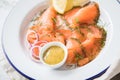 Gravlax a raw, marinated graved salmon with dill on enamel plate with Scandinavian mustard sauce, lemon, onion rings and linen Royalty Free Stock Photo