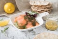 Gravlax a raw, marinated graved salmon with dill on plate with crispbread, Scandinavian mustard sauce, lemon and linen towel on Royalty Free Stock Photo